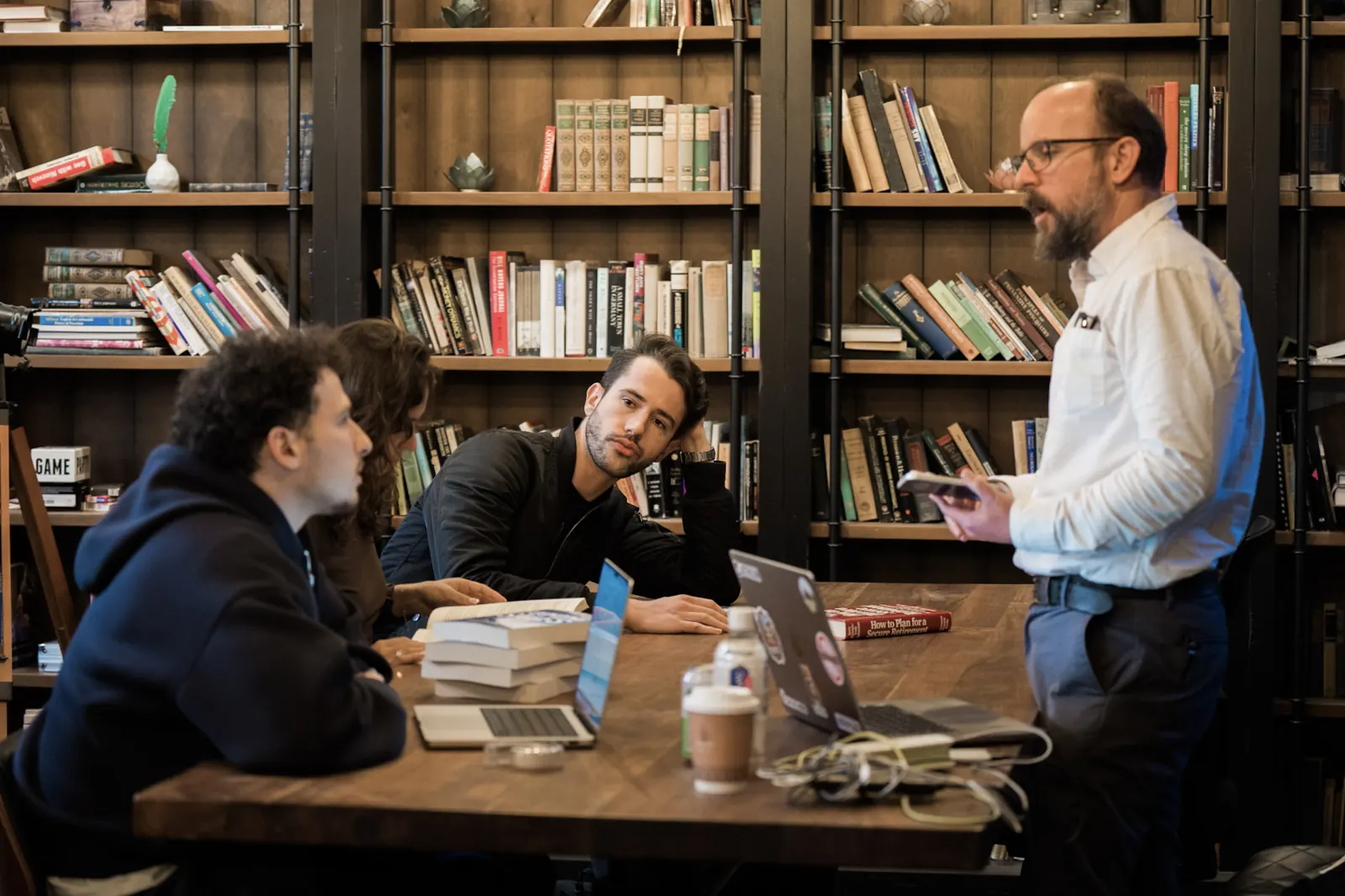 Peter Kazanjy leading the ICP definition workshop in the Wefunder library, with copies of Founding Sales on the table