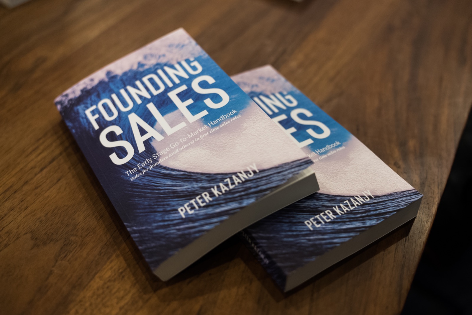 Copies of Founding Sales by Peter Kazanjy on the workshop table