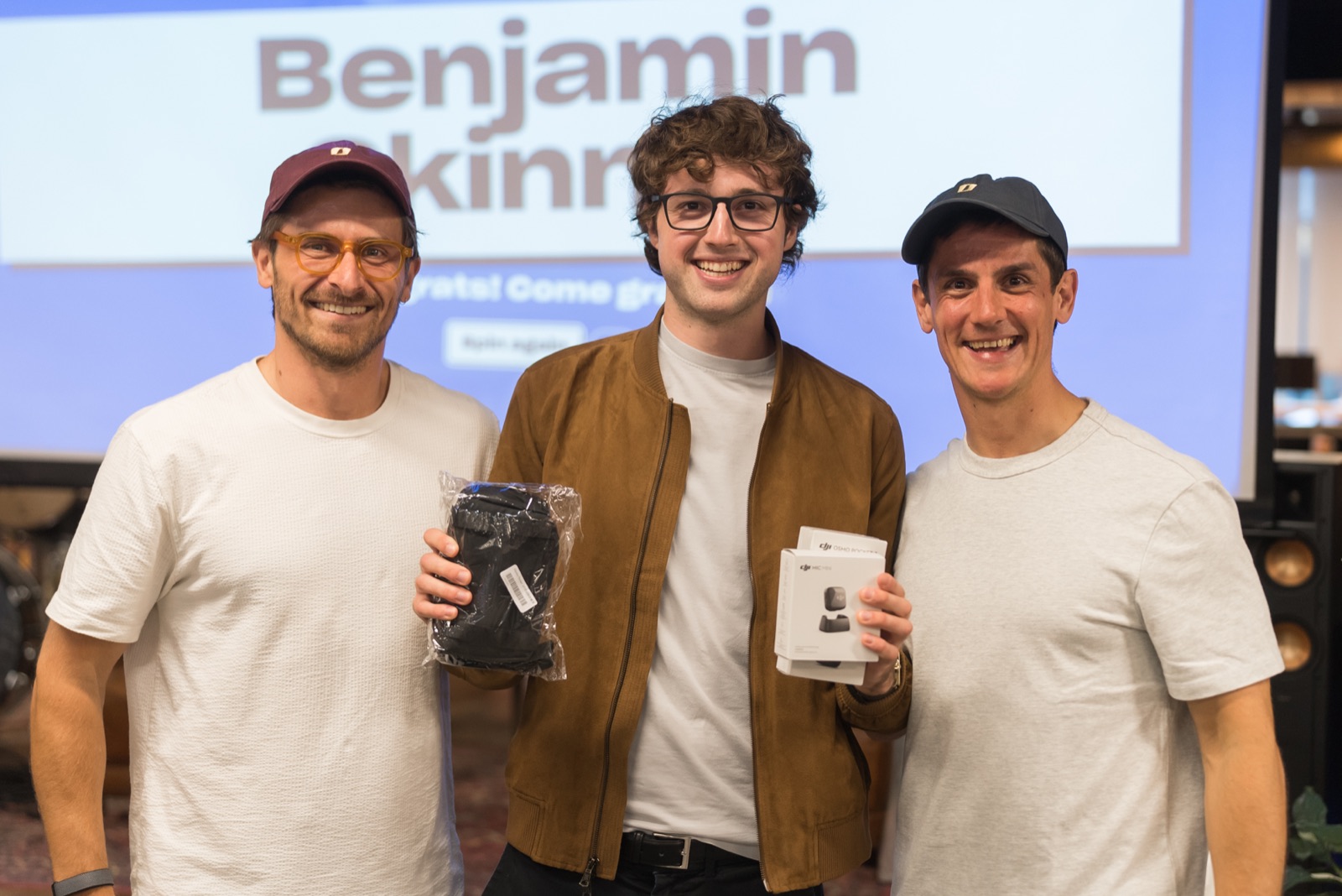 Giveaway winner Benjamin Skinner holding the DJI Osmo Pocket 3 and DJI mic, with Gui Miara and Robin Choy